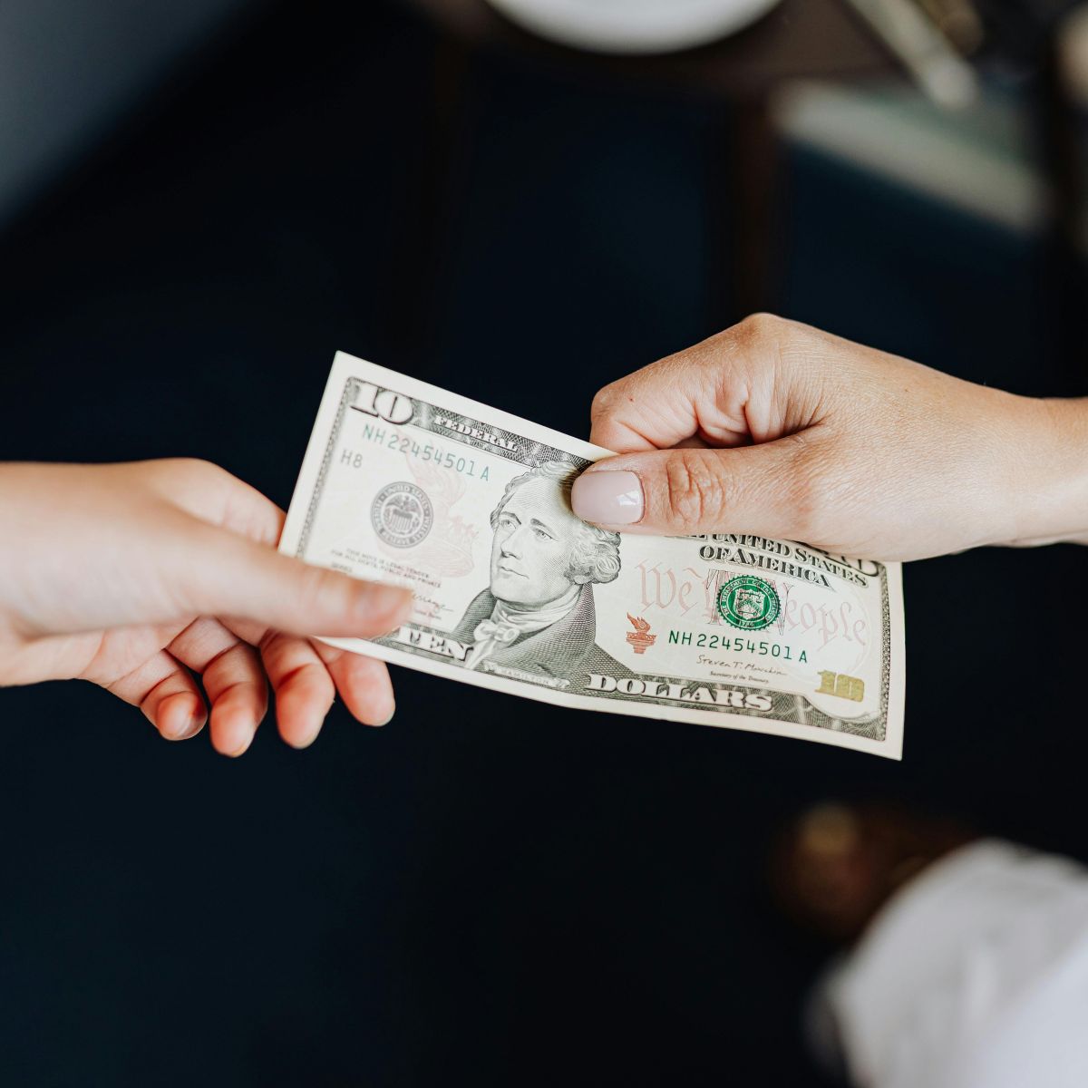 Person handing cash to another